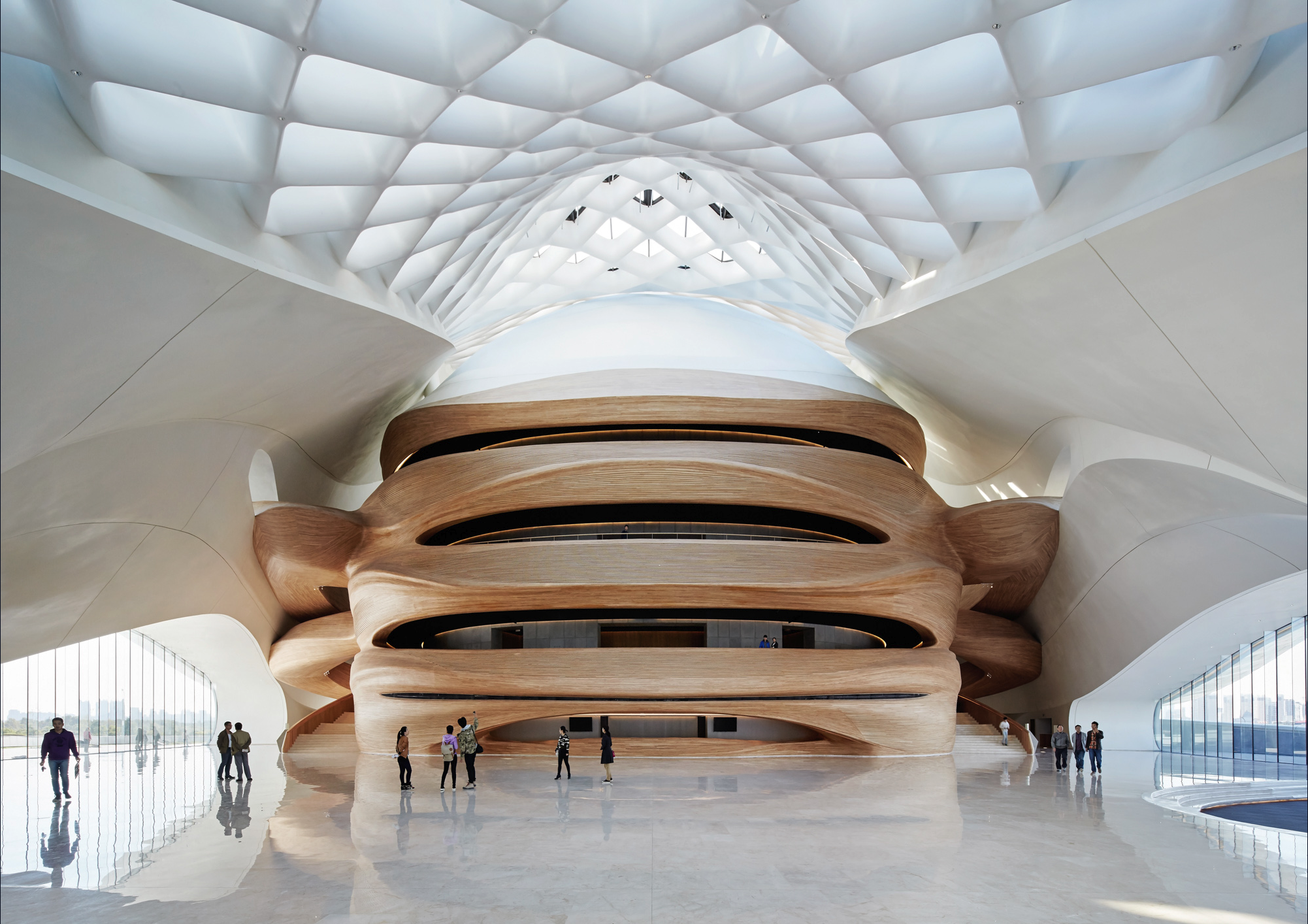 Harbin Opera House lobby: the timber-clad grand theater beneath the diagrid skylight