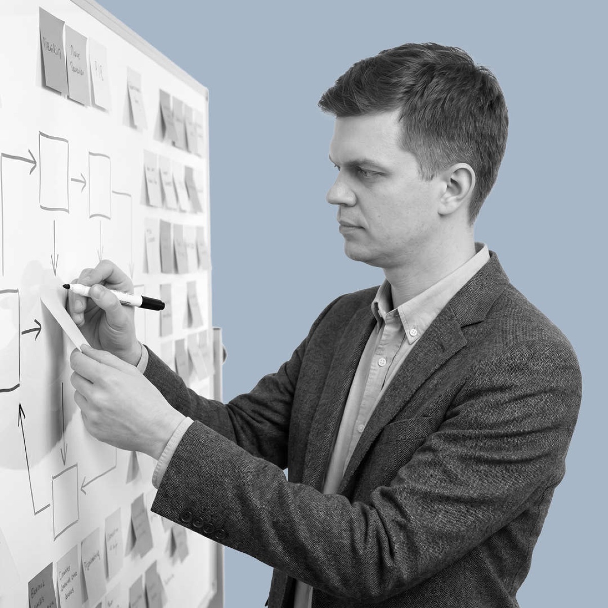 Tomasz Czarnecki sketching a workflow on a whiteboard